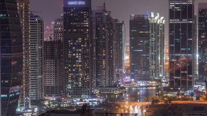 Naklejka na ściany i meble Residential and office buildings in Jumeirah lake towers district night timelapse in Dubai