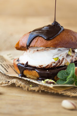 Burger with vanilla ice cream and chocolate on wood background. burger sweet