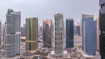Residential and office buildings in Jumeirah lake towers district night to day timelapse in Dubai