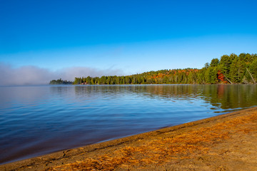 Morning Mist in Lake of Two Rivers in Algonquin Park, Ontario, Canada