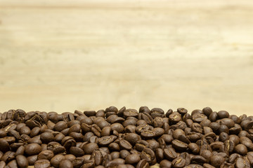 Fresh coffee beans with a wooden floor backdrop