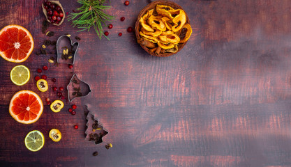Fall and winter ingredients still life with grapefruits, lemon,cydonia, cranberries, herbs, dried apples, cinnamon sticks, spices, raisin on wooden background, antioxidants, vitamin C rich food