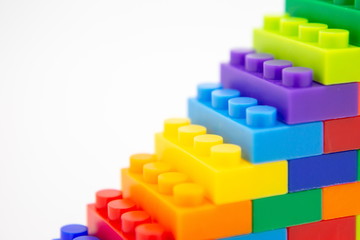 brick blocks stairs cube toy mini figures colorful on white background . building plastic fun...