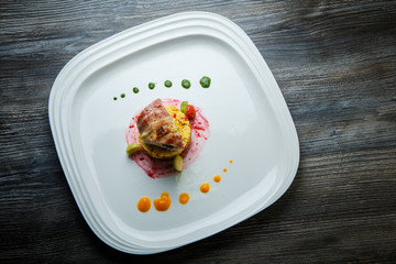 top view on delicious meat roll served on quinoa with vegetables