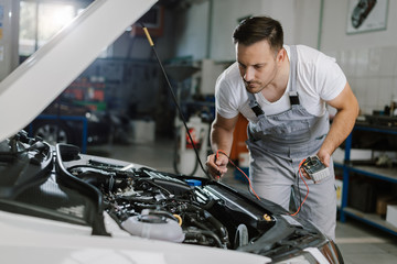 Auto mechanic working on car diagnostic in a repair shop