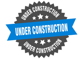 under construction sign. under construction blue-black circular band label