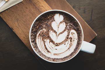 Fresh coffee that has been created to create a leaf pattern in a white coffee cup at a coffee shop in Thailand.