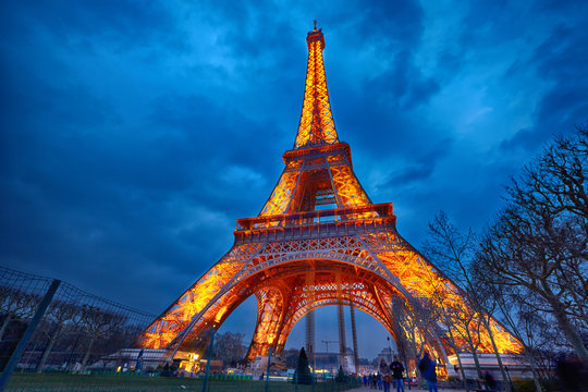 closeup of illuminated Eiffel Tower at night, Paris
