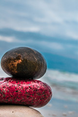 Zen stones on the beach with sand and sea view