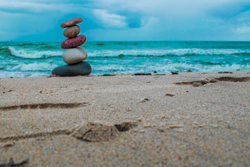Plakat Zen stones on the beach with sand and sea view