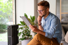 Young smiling Man typing on digital tablet	