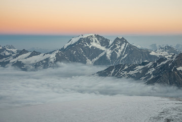 Fototapeta na wymiar view of the main Caucasian ridge from the slopes of the highest peak in Europe, Mount Elbrus