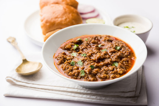 Kheema / keema Pav or Khima Paav is a spicy curry dish made up of minced chicken or lamb cooked with onion, tomatoes, served with buns. selective focus