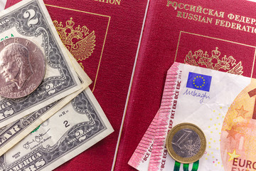 Russian passport, bills and coins of the Euro and the dollar
