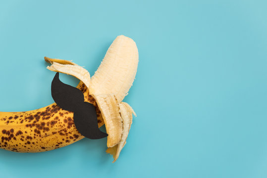 Open bad banana with black paper mustache. Sexually transmitted diseases concept.