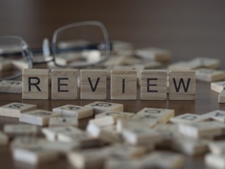 The concept of Review represented by wooden letter tiles