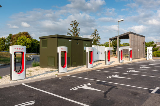 Reims, France - August 27, 2018: Tesla Super Charging station on highway rest stop. Tesla Supercharger stations allow Tesla cars to be fast-charged at the network within an hour.