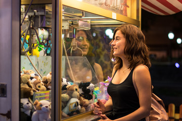 Young woman is playing a game in a fair