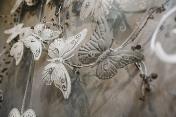 Decorative butterflies on a wall with white background.