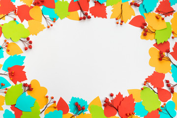 Autumn composition frame Paper colored leaves branches berries on white background The concept of autumn Flat lay top view