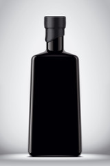 Glass black bottle on gray background