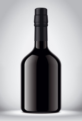 Glass black bottle on gray background