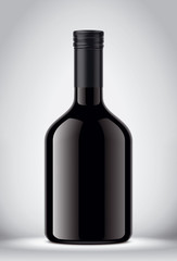 Glass black bottle on gray background