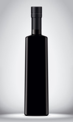 Glass black bottle on gray background