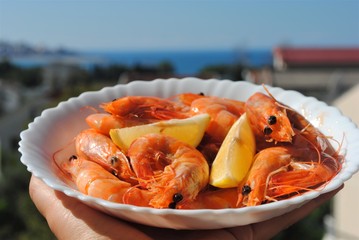 Cooking fresh seafood. Shrimp, stingray, dorado and seabass on a plate.