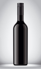 Glass black bottle on gray background