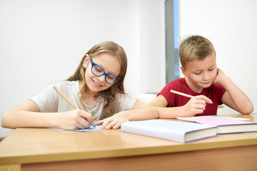 Fototapeta premium Smart students sitting in classroom and doing test at school