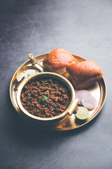 Kheema / keema Pav or Khima Paav is a spicy curry dish made up of minced chicken or lamb cooked with onion, tomatoes, served with buns. selective focus