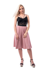 Uncertain displeased young blonde classy elegant woman looking away. Full body isolated on white background. 