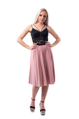 Bossy displeased young woman with attitude and style holding hands on hips looking at camera. Full body isolated on white background. 