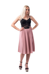 Angry displeased blonde woman in classy style with hands on hips looking away. Full body isolated on white background. 