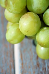 green grapes on blurred background in light