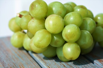 green grapes on wooden table