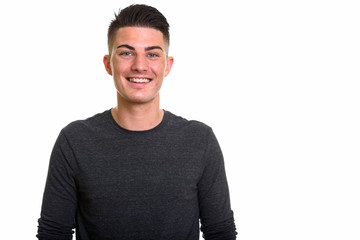 Studio shot of young happy handsome man smiling