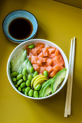 Hawaiian Poke Bowl with Salmon, Edamame, Takuan, Avocado, Cucumber Slices and Rice.