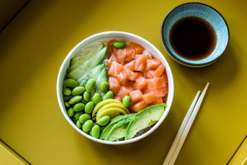 Hawaiian Poke Bowl with Salmon, Edamame, Takuan, Avocado, Cucumber Slices and Rice.