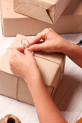 The girl is wrapping gifts. The concept of holiday, christmas, new year, surprise