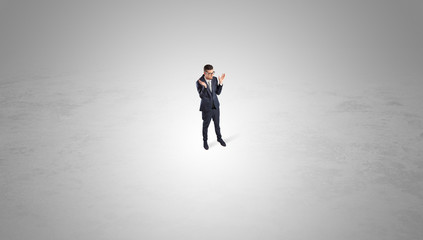 Young businessman standing alone in the middle of an empty space