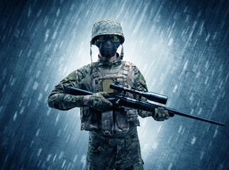 Armed soldier standing in rainy weather