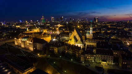Aerial view of the Old city night Warsaw with the square and the royal palace in the night lighting. 