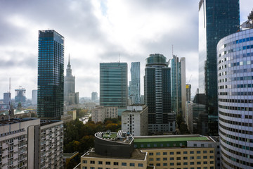 Drone shot at skyscrapers and buildings in the fog. Warsaw Poland. 24. September. 2019. Aerial view on the silhouettes of modern office buildings in the fog at morning. 