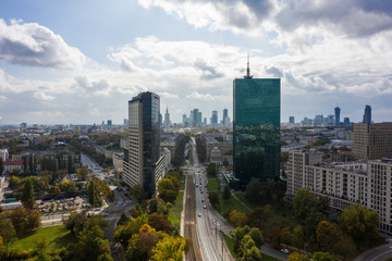 Fototapeta na wymiar Aerial view of an urban metropolis with modern architecture and buildings at sunset. Warsaw. Poland. 19. September. 2019. Drone shot on cityscape business downtown.