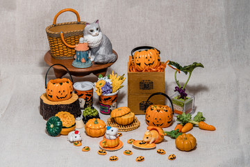 halloween holiday decoration concept, A lot of halloween party object miniature toys decoration on wrinkled calico background.