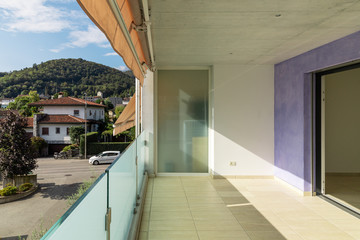 Balcony with travertine flooring, lilac facade