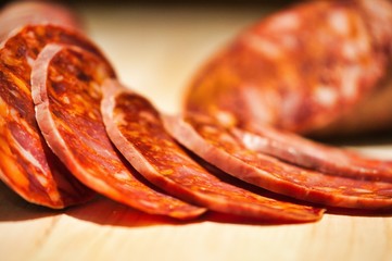 Closeup shot of sliced sausage on a wooden table