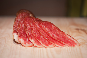  closeup shot of sliced red meat on a wooden surface 